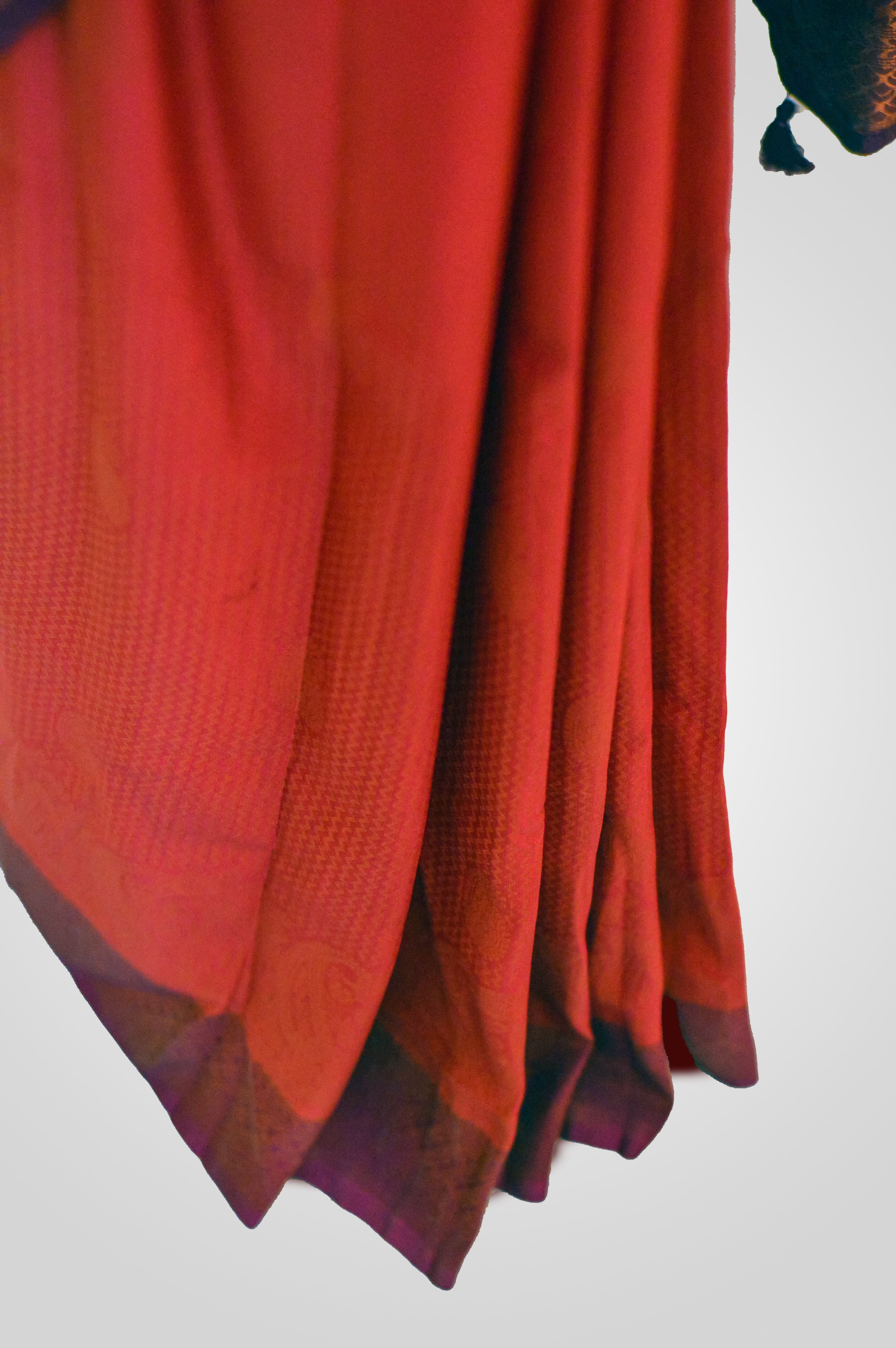 Kaloshmi samudrika pattu saree (silk, vibrant orange) Draped on a dummy at a studio setup -front view
