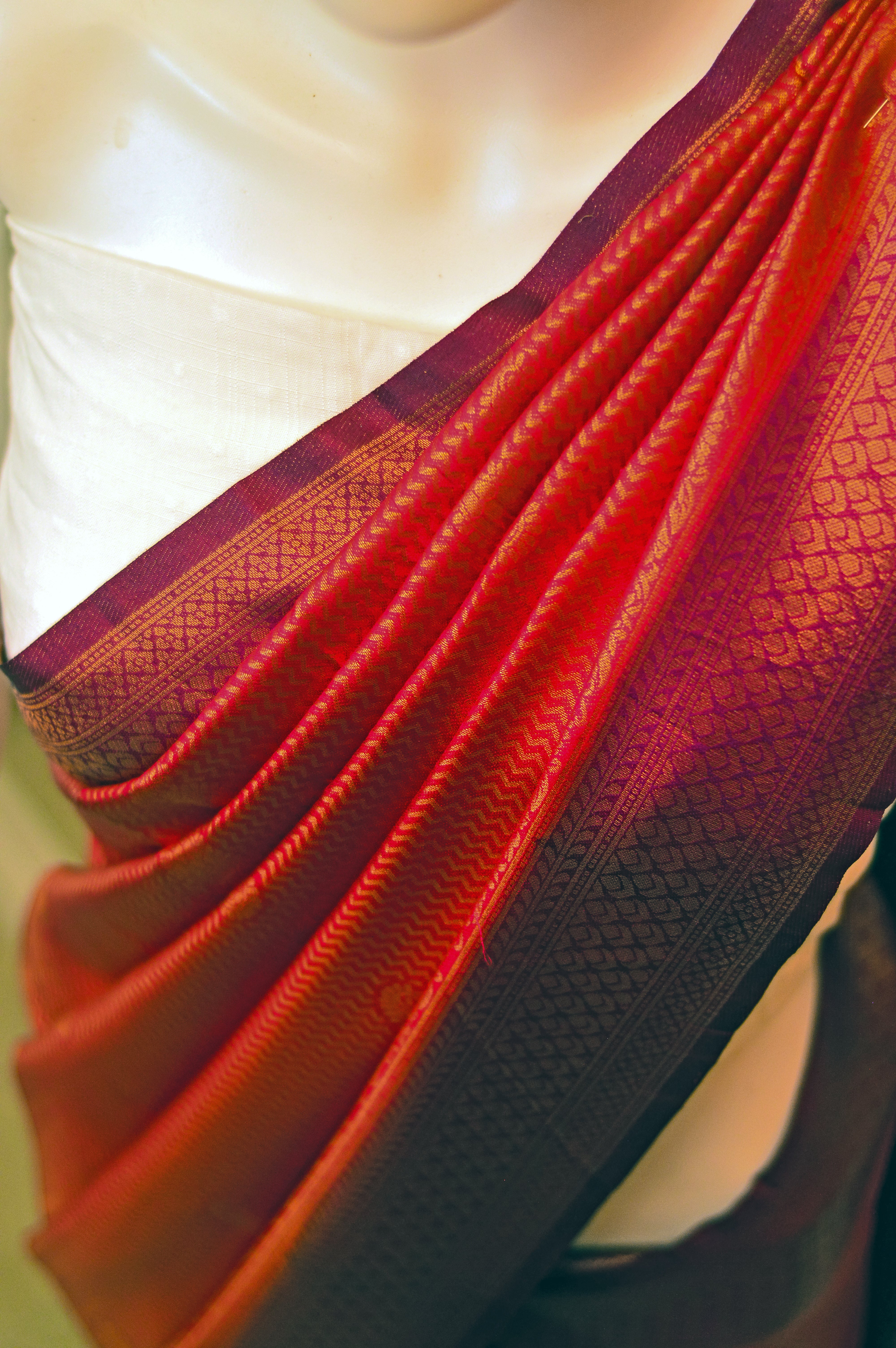 Kaloshmi samudrika pattu saree (silk, vibrant orange) Draped on a dummy at a studio setup -front  pallu view