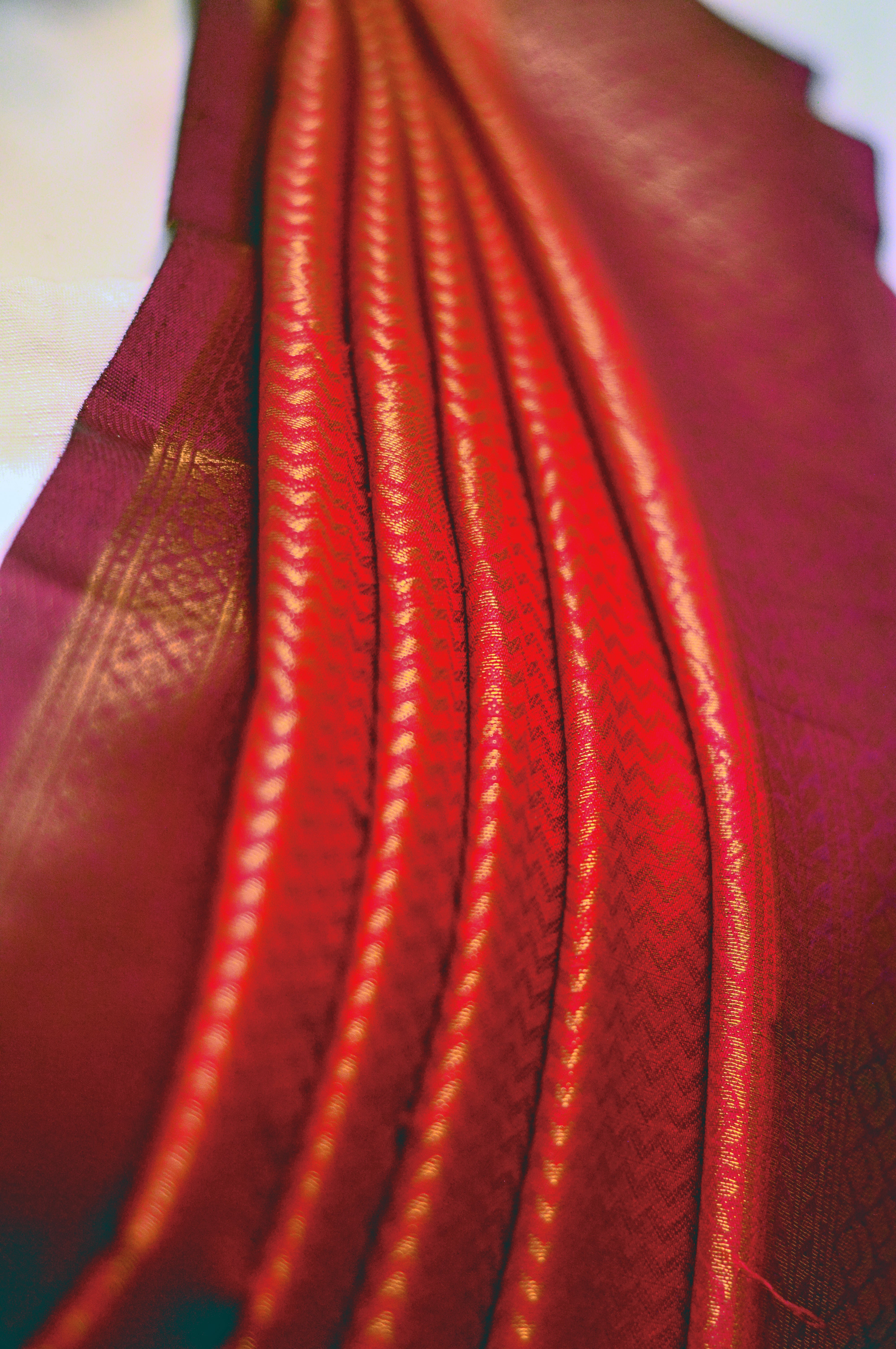 Kaloshmi samudrika pattu saree (silk, vibrant orange) Draped on a dummy at a studio setup -front pallu view